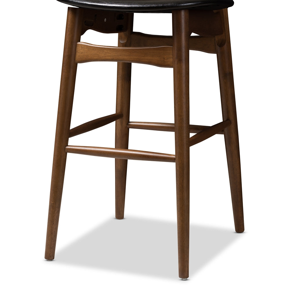 BAXTON STUDIO FLORA MID-CENTURY MODERN BLACK FAUX LEATHER UPHOLSTERED WALNUT FINISHED BAR STOOL (SET OF 2)