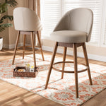 Load image into Gallery viewer, Baxton Studio Carra Mid-Century Modern Light Beige Fabric Upholstered Walnut-Finished Wood 2-Piece Swivel Bar Stool Set
